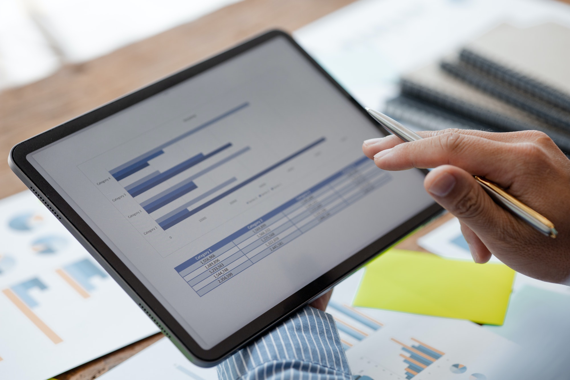 A business finance woman is reviewing a company's financial documents prepared.